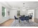 Bright dining room boasts modern chandelier, stylish decor, and a view into the kitchen at 309 N Kepler Rd, Deland, FL 32724