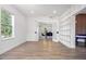 Bright empty room leading to dining room featuring modern flooring, natural light and built-in shelving at 309 N Kepler Rd, Deland, FL 32724