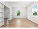 Bright, empty room with modern flooring, natural light, and built-in shelving at 309 N Kepler Rd, Deland, FL 32724