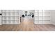 Bright hallway with modern flooring, built-in shelving and view to the living room at 309 N Kepler Rd, Deland, FL 32724