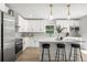 Modern kitchen with stainless steel appliances, a center island and stylish pendant lighting at 309 N Kepler Rd, Deland, FL 32724