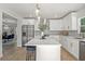 Bright kitchen featuring stainless steel appliances, island with seating, and open layout at 309 N Kepler Rd, Deland, FL 32724