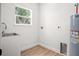 Practical laundry area with utility sink, updated flooring, and space for appliances at 309 N Kepler Rd, Deland, FL 32724