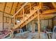 Unfinished shed interior with plywood walls, open beams and staircase to second floor at 309 N Kepler Rd, Deland, FL 32724