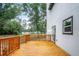 View of spacious wooden deck featuring wood railings and side door access at 309 N Kepler Rd, Deland, FL 32724
