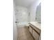 Bathroom featuring modern marble-style tiles, tub/shower combo, and well-lit vanity at 3124 S Semoran Blvd # 206, Orlando, FL 32822