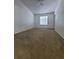 Light-filled bedroom with carpet, a ceiling fan, neutral walls, and a large window at 3124 S Semoran Blvd # 206, Orlando, FL 32822