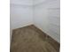 Walk-in closet featuring carpet flooring and open wire shelving for optimal storage at 3124 S Semoran Blvd # 206, Orlando, FL 32822