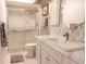 Bright bathroom featuring a walk-in shower and marble countertop vanity with patterned accent wall at 314 Windmeadows St # 314, Altamonte Springs, FL 32701