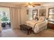 Cozy bedroom featuring a comfortable bed, soft carpet, and access to an enclosed porch at 314 Windmeadows St # 314, Altamonte Springs, FL 32701