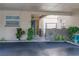 Inviting condo entrance with covered parking, lovely landscaping, and a charming blue door at 314 Windmeadows St # 314, Altamonte Springs, FL 32701