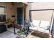 Welcoming entryway with a cozy swing, blue door, and lush landscaping, enhancing the home's curb appeal at 314 Windmeadows St # 314, Altamonte Springs, FL 32701