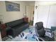 Cozy living space featuring sleek black sofa and bright floral rug with stylish decor at 314 Windmeadows St # 314, Altamonte Springs, FL 32701
