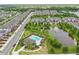 Aerial view of townhome community featuring pool, pond with fountain, and well-manicured landscaping at 328 Cedar Bark Ln, Sanford, FL 32771