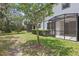 Landscaped backyard with a screened patio for outdoor enjoyment and relaxation at 328 Cedar Bark Ln, Sanford, FL 32771