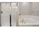 Clean bathroom features a walk-in shower with glass door and a separate soaking tub at 328 Cedar Bark Ln, Sanford, FL 32771