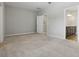 Spacious bedroom with neutral carpet, grey walls, and a view of the en-suite bathroom at 328 Cedar Bark Ln, Sanford, FL 32771
