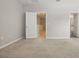Bedroom with neutral walls features a door leading to the en-suite bathroom at 328 Cedar Bark Ln, Sanford, FL 32771