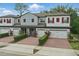 Townhome complex showcasing stylish architecture, garage entrances, and landscaping at 328 Cedar Bark Ln, Sanford, FL 32771