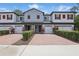 Charming townhome with red shutters, a brick paver driveway, and meticulously maintained landscaping at 328 Cedar Bark Ln, Sanford, FL 32771