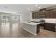 Open concept kitchen with modern stainless steel appliances and views of the living area at 328 Cedar Bark Ln, Sanford, FL 32771
