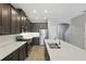 Well-equipped kitchen with stainless steel appliances, dark cabinets, and an island with a double sink at 328 Cedar Bark Ln, Sanford, FL 32771