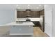 Modern kitchen with stainless steel appliances, dark cabinets, a center island, and light countertops at 328 Cedar Bark Ln, Sanford, FL 32771