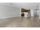 Open-concept living room featuring tile floors and a modern kitchen with stainless steel appliances at 328 Cedar Bark Ln, Sanford, FL 32771