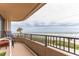 Balcony offering views of the ocean, tropical foliage, and seating area to enjoy the scene at 3360 Ocean Shore Blvd # 4050, Ormond Beach, FL 32176