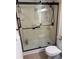 Bathroom featuring a glass-enclosed shower, toilet and updated fixtures at 3360 Ocean Shore Blvd # 4050, Ormond Beach, FL 32176