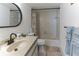 Well-lit bathroom featuring a shower-tub combo, single sink vanity, and decorative mirror at 3360 Ocean Shore Blvd # 4050, Ormond Beach, FL 32176