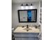 Bathroom featuring a vanity sink with a black frame mirror at 3360 Ocean Shore Blvd # 4050, Ormond Beach, FL 32176