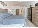 Bedroom featuring a comfortable bed, storage furniture, and an adjacent bathroom at 3360 Ocean Shore Blvd # 4050, Ormond Beach, FL 32176