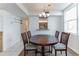 Bright dining area featuring a round table with chairs and a peek into the kitchen at 3360 Ocean Shore Blvd # 4050, Ormond Beach, FL 32176