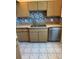 Functional kitchen featuring stainless steel appliances and neutral cabinets and backsplash at 3360 Ocean Shore Blvd # 4050, Ormond Beach, FL 32176
