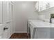 Functional laundry room featuring a washer, dryer, storage cabinets, and bifold door at 3360 Ocean Shore Blvd # 4050, Ormond Beach, FL 32176