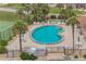 Overhead view of a kidney shaped pool surrounded by lounge furniture and tropical landscaping at 3360 Ocean Shore Blvd # 4050, Ormond Beach, FL 32176