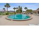 Community pool featuring lounge chairs, palm trees, and a seven-foot depth marking at 3360 Ocean Shore Blvd # 4050, Ormond Beach, FL 32176