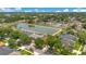 Expansive aerial shot of a community with a large pond, showcasing numerous homes and lush landscaping at 4047 Lillian Hall Ln, Orlando, FL 32812