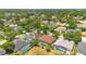 An aerial view shows a neighborhood with mature trees and several homes with screened in pools in their backyards at 4047 Lillian Hall Ln, Orlando, FL 32812