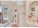 Bathroom featuring vanity with sink, toilet, and shower with glass door with view to pool at 4047 Lillian Hall Ln, Orlando, FL 32812