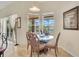 Casual dining area features a glass table with seating, with views of the screened in lanai and yard at 4047 Lillian Hall Ln, Orlando, FL 32812