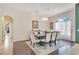 Spacious dining room with a dark wood table, upholstered chairs, and plenty of natural light at 4047 Lillian Hall Ln, Orlando, FL 32812