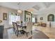 Open-concept dining area with seating for eight, stylish lighting, and an adjacent living space at 4047 Lillian Hall Ln, Orlando, FL 32812