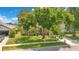 Beautiful home with lush landscaping, mature trees, and a well-maintained front yard on a sunny day at 4047 Lillian Hall Ln, Orlando, FL 32812