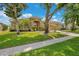 Attractive single-story home with a green lawn, mature trees, and a convenient two-car garage at 4047 Lillian Hall Ln, Orlando, FL 32812