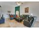 Bright living room with tile floors, vaulted ceilings, ceiling fan, and comfortable seating with decorative features at 4047 Lillian Hall Ln, Orlando, FL 32812