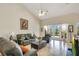 Spacious living room features tile flooring, high ceilings, and sliding glass doors to the outdoor lanai at 4047 Lillian Hall Ln, Orlando, FL 32812