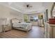 Main bedroom featuring hardwood floors, ceiling fan, and views of the outdoor lanai and back yard at 4047 Lillian Hall Ln, Orlando, FL 32812