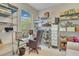 Bright and functional home office featuring ample storage, a glass desk, and natural light at 4047 Lillian Hall Ln, Orlando, FL 32812